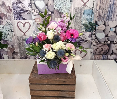 Love letters lavender - A romantic floral arrangement featuring a beautiful blend of blush pink, soft lavender, creamy white, and vibrant accents, complemented by fresh greenery and presented in a stylish keepsake gift box. Finished with a delicate ribbon