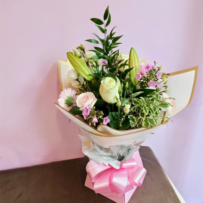 Blush & Ivory Elegance - A graceful hand-tied bouquet designed in soft blush pink, creamy ivory, and fresh green tones. Beautifully presented in elegant gold-edged wrapping and finished with a statement pink bow, this charming arrangement has a romantic and sophisticated feel. A lovely choice for birthdays, anniversaries, thank-you gifts, new baby celebrations, or simply sending someone a thoughtful