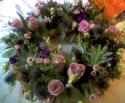 A Gentle Farewell - A tribute as unique as the life it honours, this whimsical wreath is lovingly handcrafted in soft, soothing shades of purple. Blending delicate roses, lisianthus, and seasonal blooms with textured greenery and sculptural succulents, it offers a heartfelt expression of remembrance and peace.

The gentle swirl of colour and form creates a sense of natural movement, while the succulents add depth, longevity, and a quiet strength — symbolising enduring love and cherished memories. Each element is thoughtfully chosen to evoke comfort, grace, and a touch of whimsy.

Designed in the timeless shape of a ring to represent eternity, this floral tribute is perfect for funeral services, memorials, or graveside farewells. It brings beauty and softness to even the hardest goodbyes.
 
Custom variations are available upon request.
Lovingly made and delivered with care throughout Newton Abbot